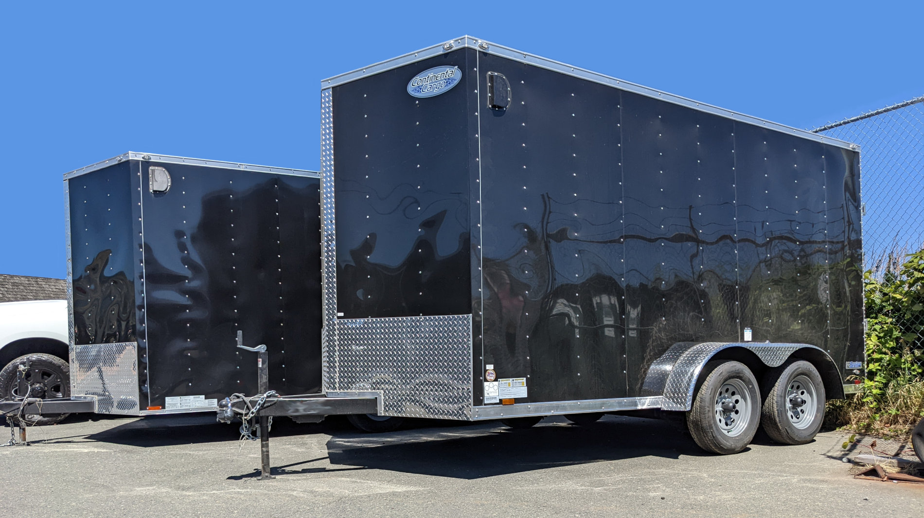 Two Continental Cargo Trailers for sale at Thomcat Equipment on the trailer sales lot.