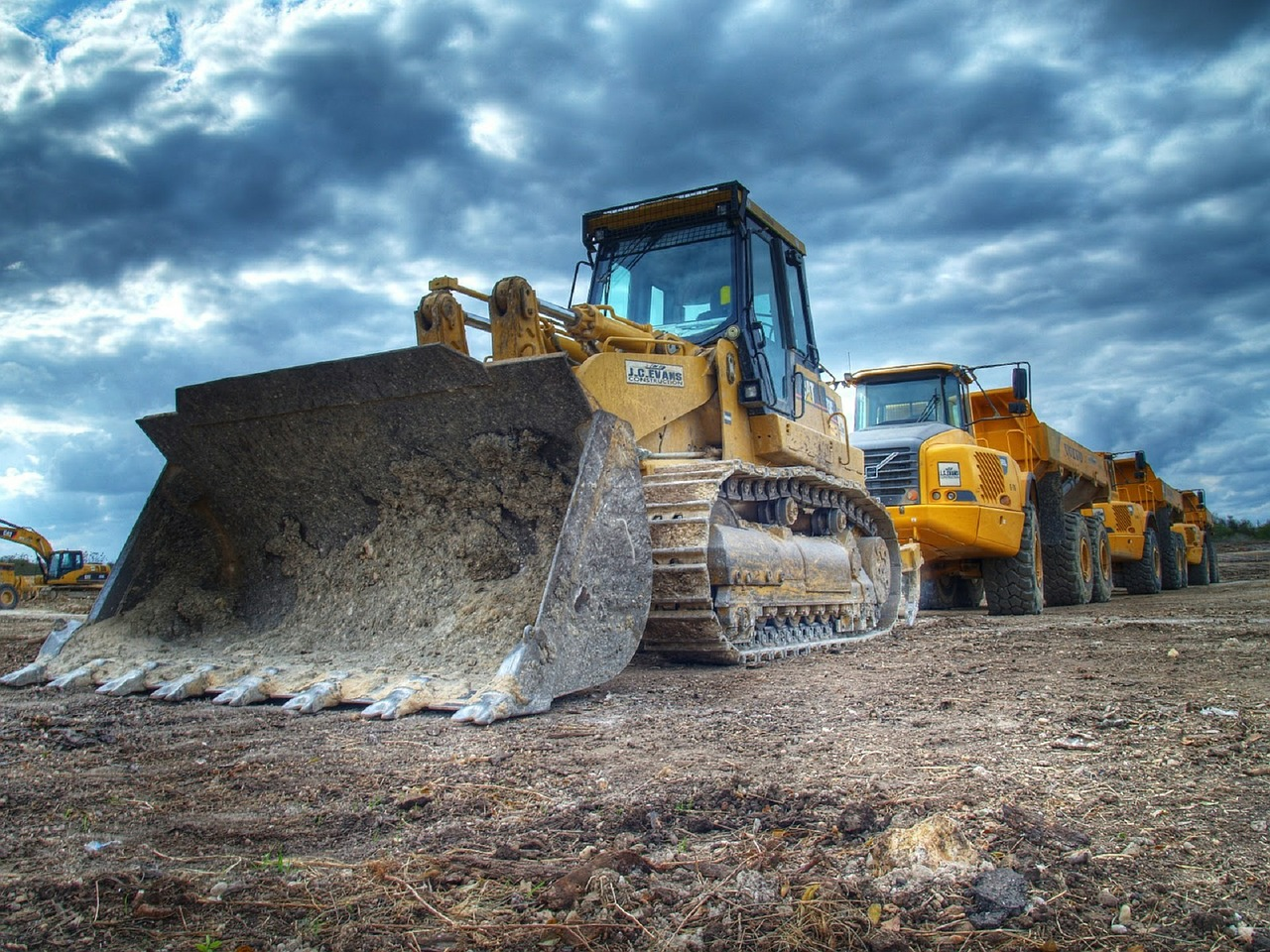 bulldozer-and-equipment-line A lineup of leasable construction machinery against a cloudy sky.